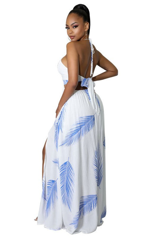 Stylish Halter Neck Maxi Dress featuring a deep neckline, self-tie back, and elegant draped skirt, perfect for any occasion.