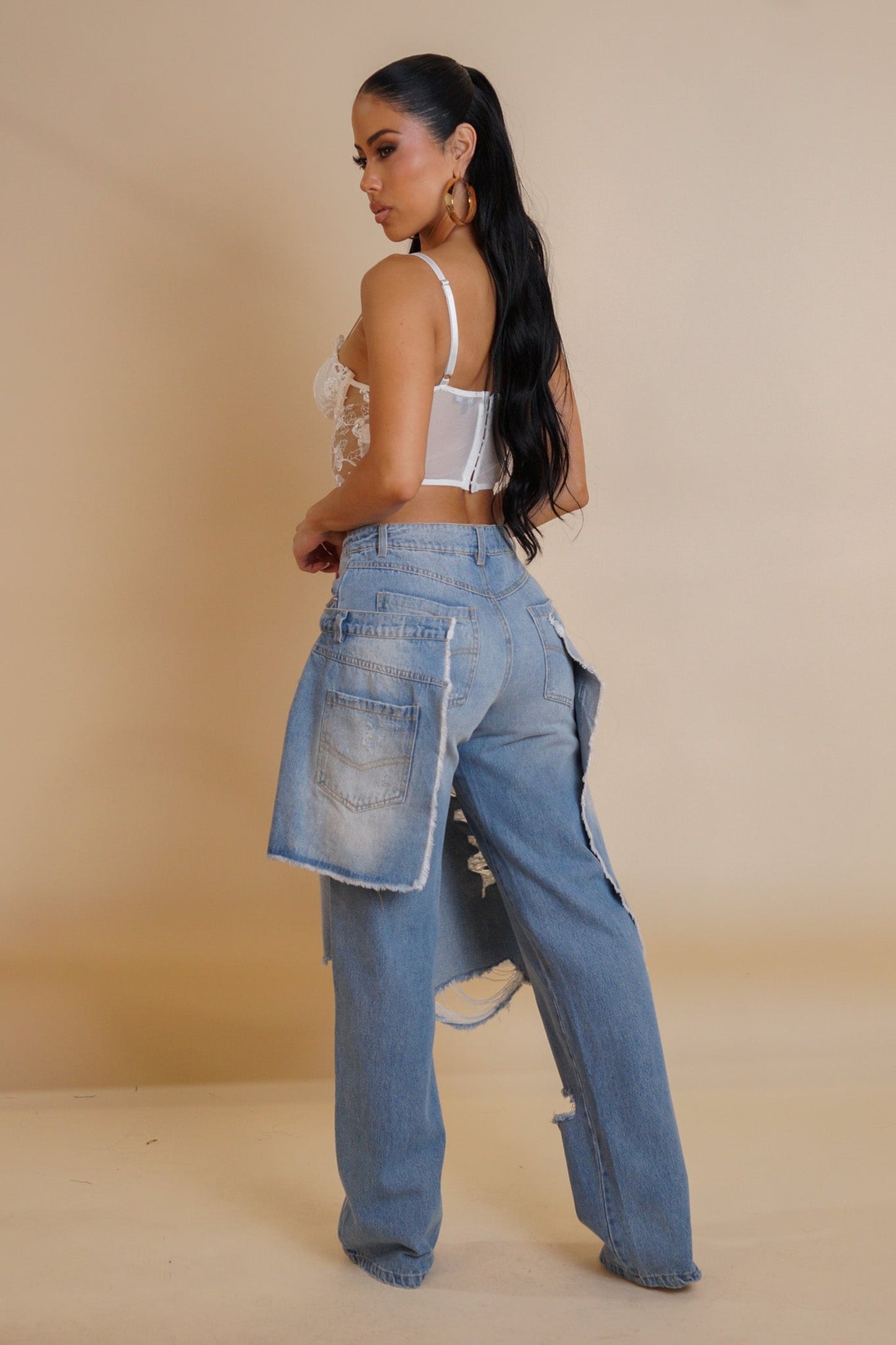 BeaChic Chic Chaos Denim: model in double-layered, distressed jeans with white lace top.