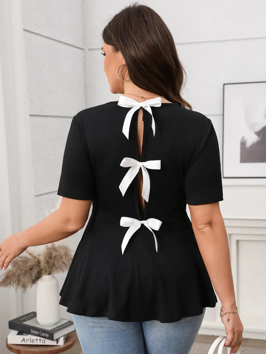 Stylish Bow Back Short Sleeve Blouse features elegant bows and a flattering peplum design, perfect for any occasion.