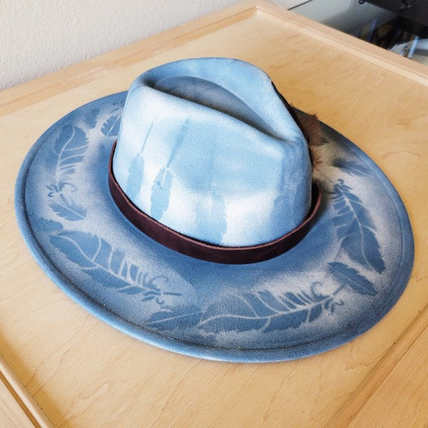 Custom hand-painted branded cowgirl western boho hat with feather and stone accents and genuine leather band, perfect for standout western style.