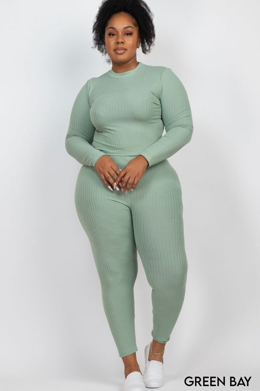 Plus-size model wearing sage green ribbed mock-neck long-sleeve top and leggings set.