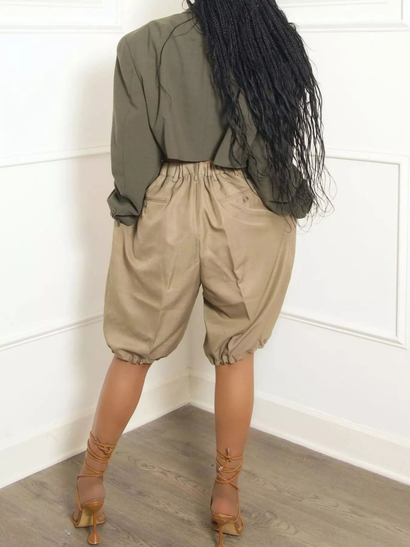 Back view of khaki Pleated Detail High Waist Shorts with drawstring and pockets, 95% polyester, 5% spandex.