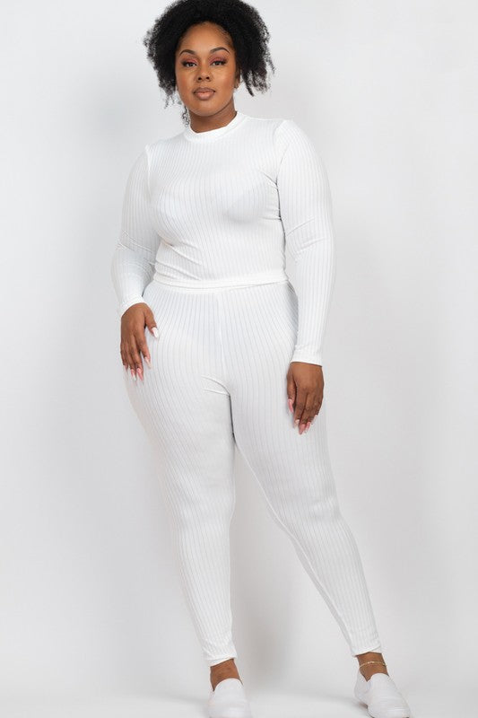 Plus-size woman in white ribbed mock-neck long-sleeve top and matching leggings set, soft stretchy knit.