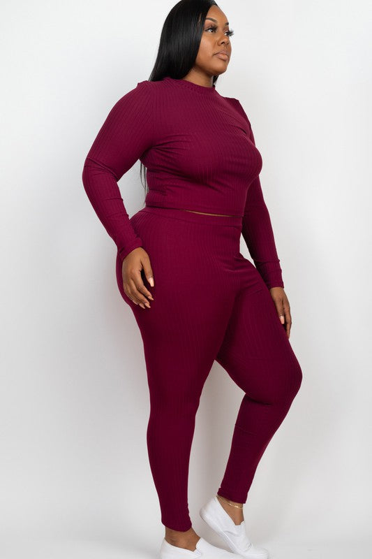 Plus-size model in burgundy ribbed mock-neck long-sleeve top and matching leggings set.