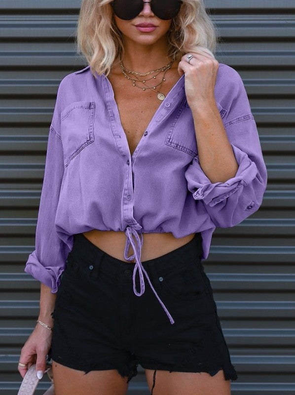 Stylish denim cropped top featuring a button front and drawstring hem, perfect for summer outfits.