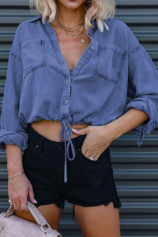 Stylish denim cropped top with button front and drawstring hem, perfect for a chic casual look.