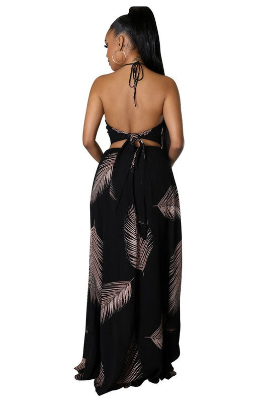 Elegant Halter Neck Maxi Dress featuring a deep neckline, open back, and a beautifully draped skirt, perfect for any occasion.