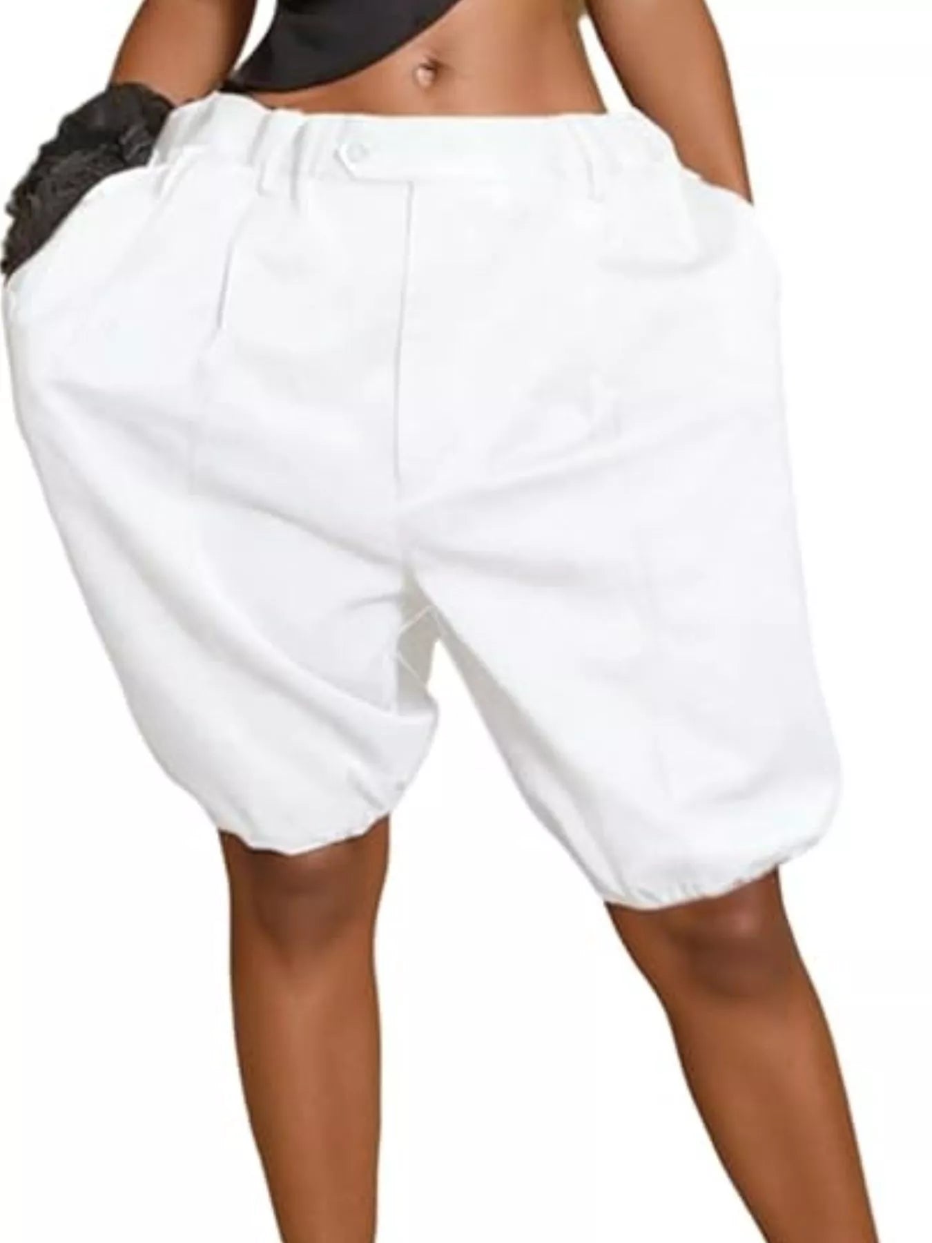 Model wearing white pleated high-waist shorts with pockets and drawstring.