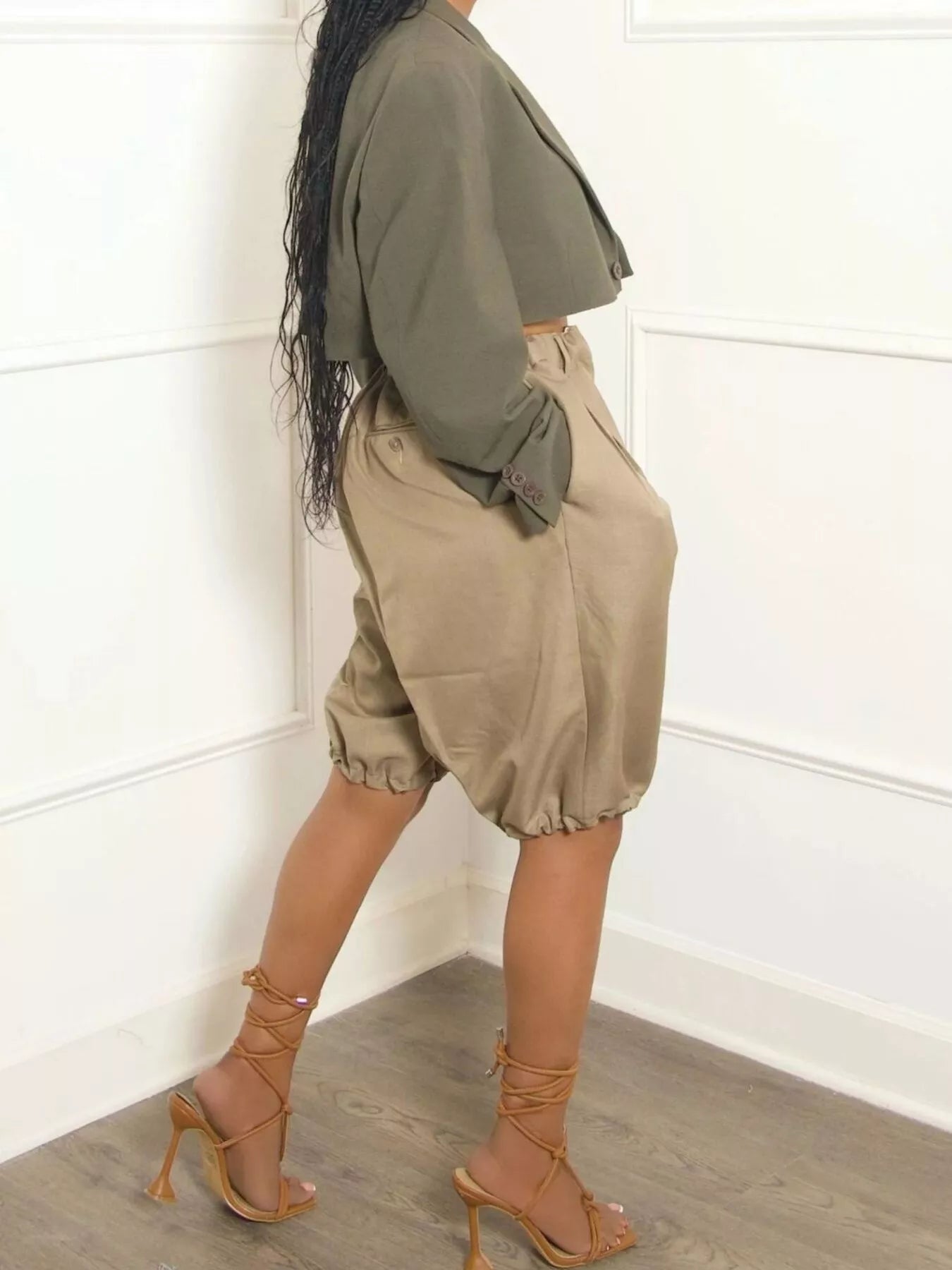 Pleated Detail High Waist Shorts with pockets and drawstring in beige, paired with olive cropped jacket.