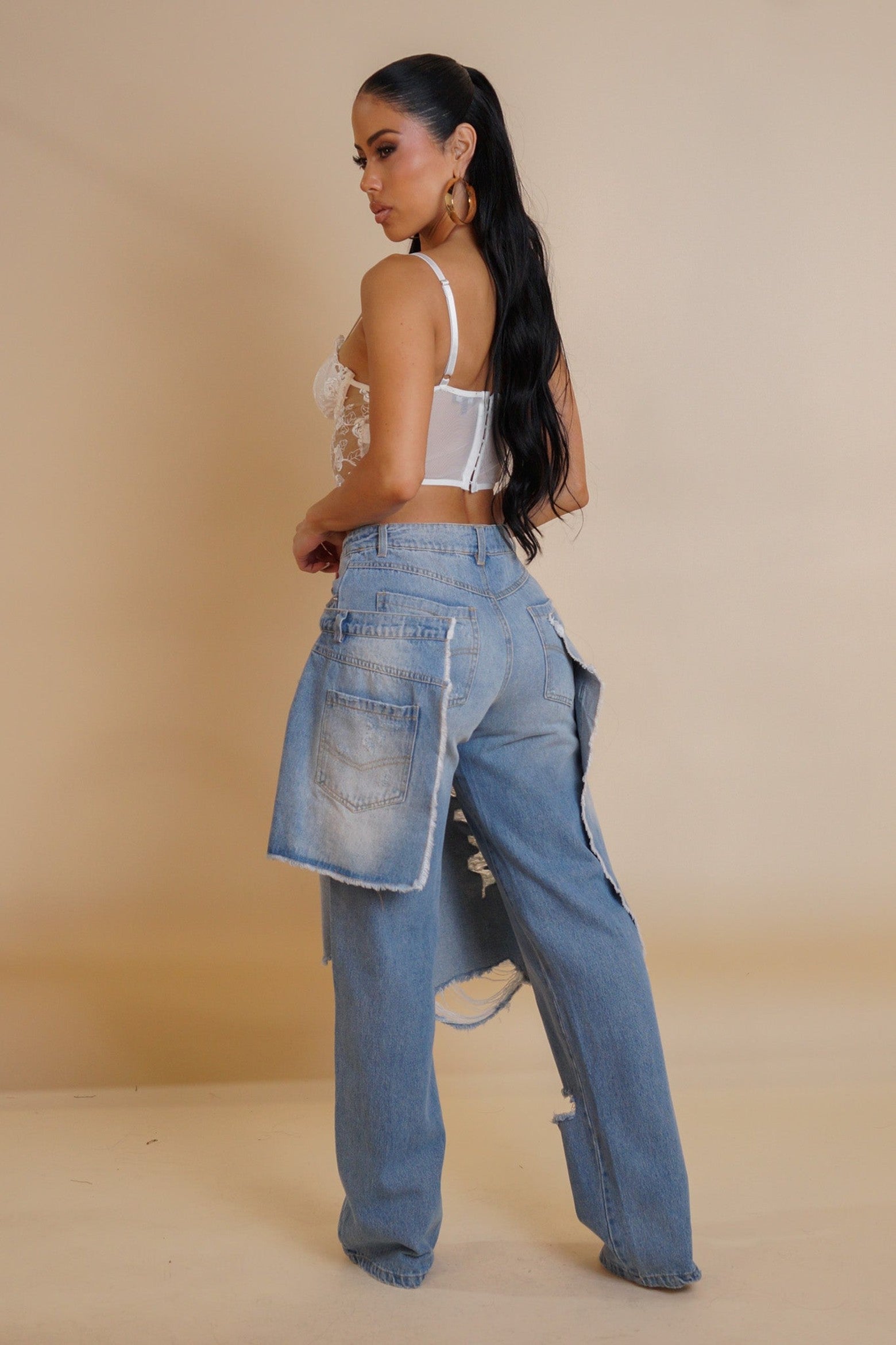 BeaChic Chic Chaos Denim: model in double-layered, distressed jeans with white lace top.